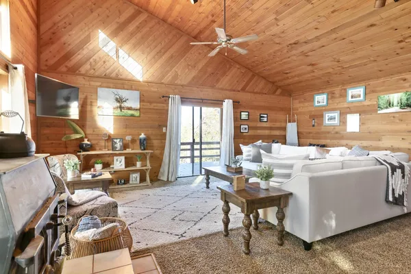 a dining room with furniture and a large window