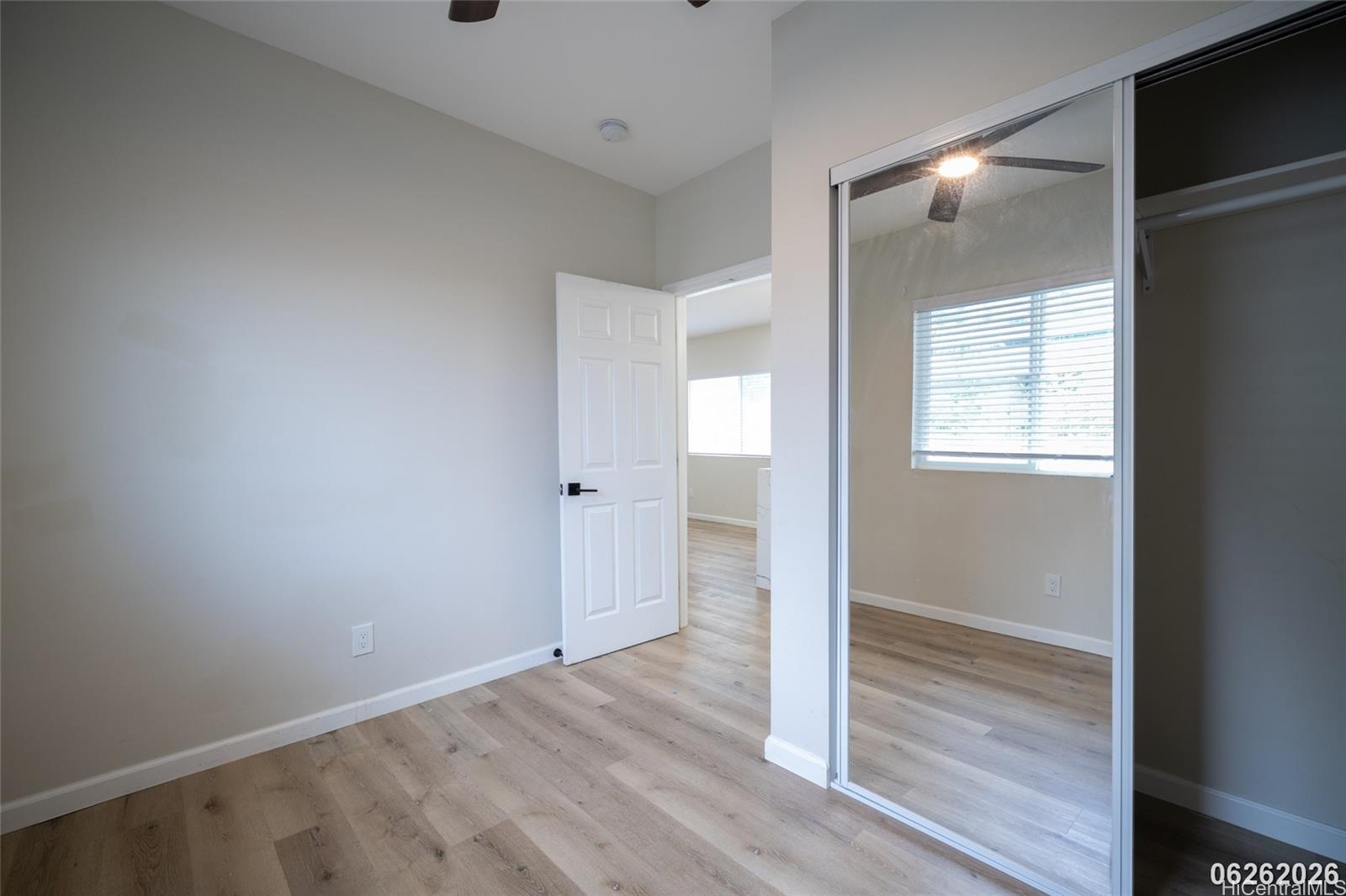 87-1409 Akowai Road Waianae, HI 96792 - Photo 17 of 25 a view of an empty room and wooden floor