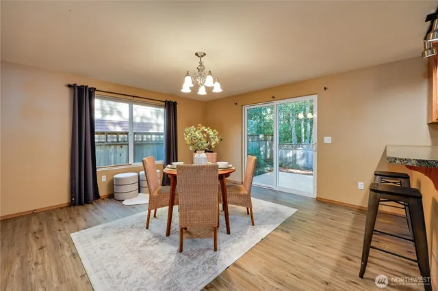 a dining room with furniture a rug and wooden floor