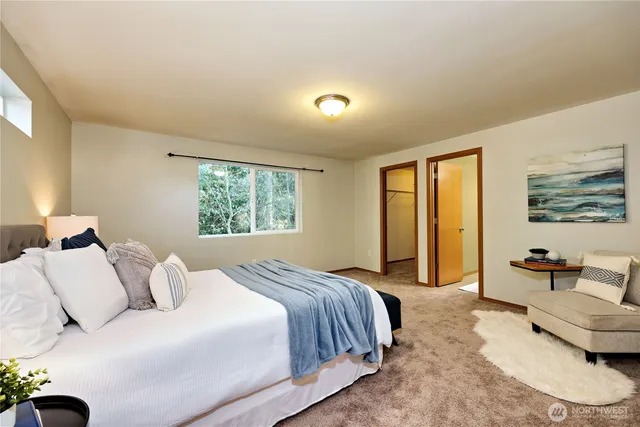 a bedroom with a large bed and a window