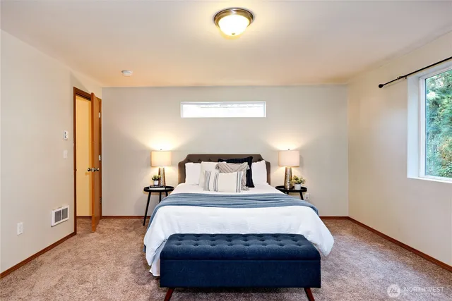 a bedroom with a bed and a night stand