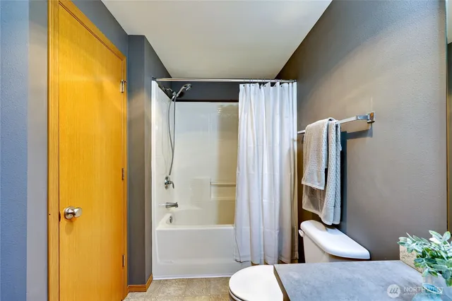 a bathroom with a toilet and a bathtub