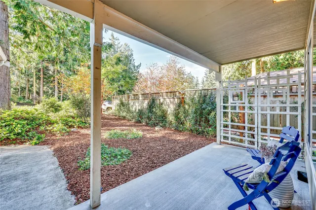 a view of a porch with chairs and a yard