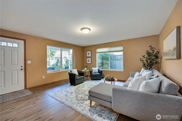 a living room with furniture and wooden floor