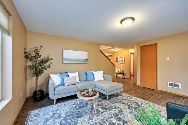 a living room with furniture and a potted plant