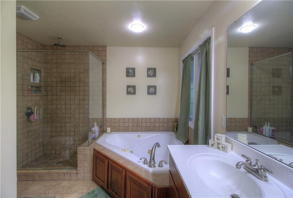 569 Leeper Road Georgetown, PA 15043 - Photo 14 of 25 Master bathroom with jacuzzi tub and stand-up tile shower. Double sinks!