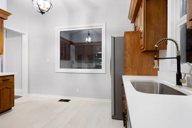a bathroom with a tub sink and mirror