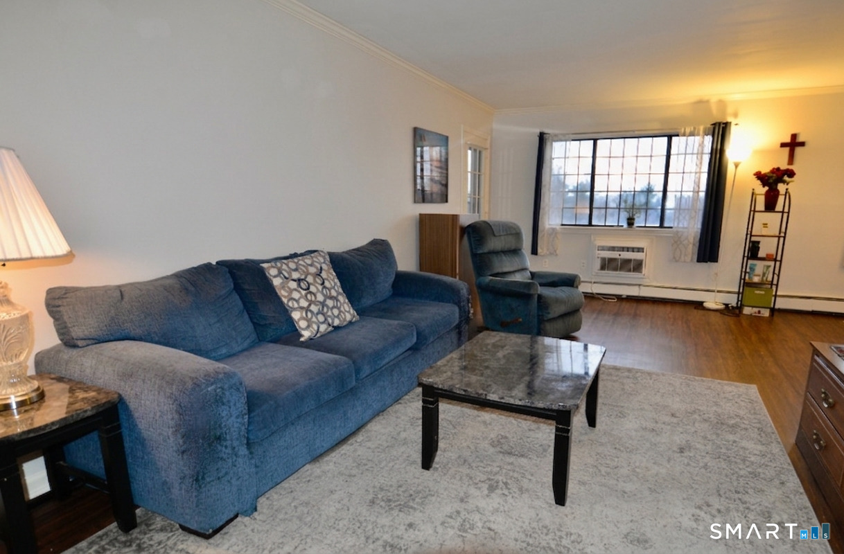 125 Warner Hill Road, Unit 67 Stratford, CT 06614 - Photo 6 of 14 Step into a sun-filled living room that feels like a warm embrace, flowing effortlessly onto the back deck-perfect for savoring morning coffee, morning sunrises, or simply letting the indoors and outdoors become one.