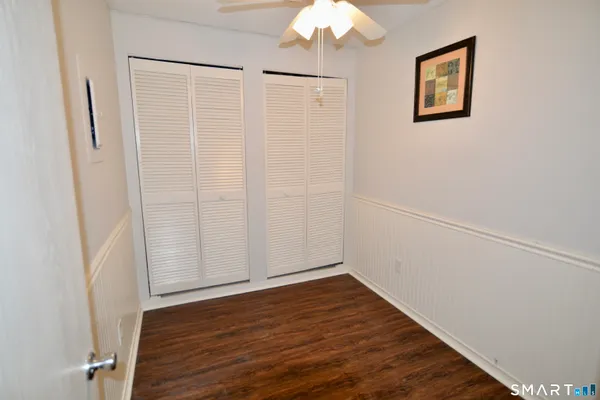 an empty room with wooden floor and white walls