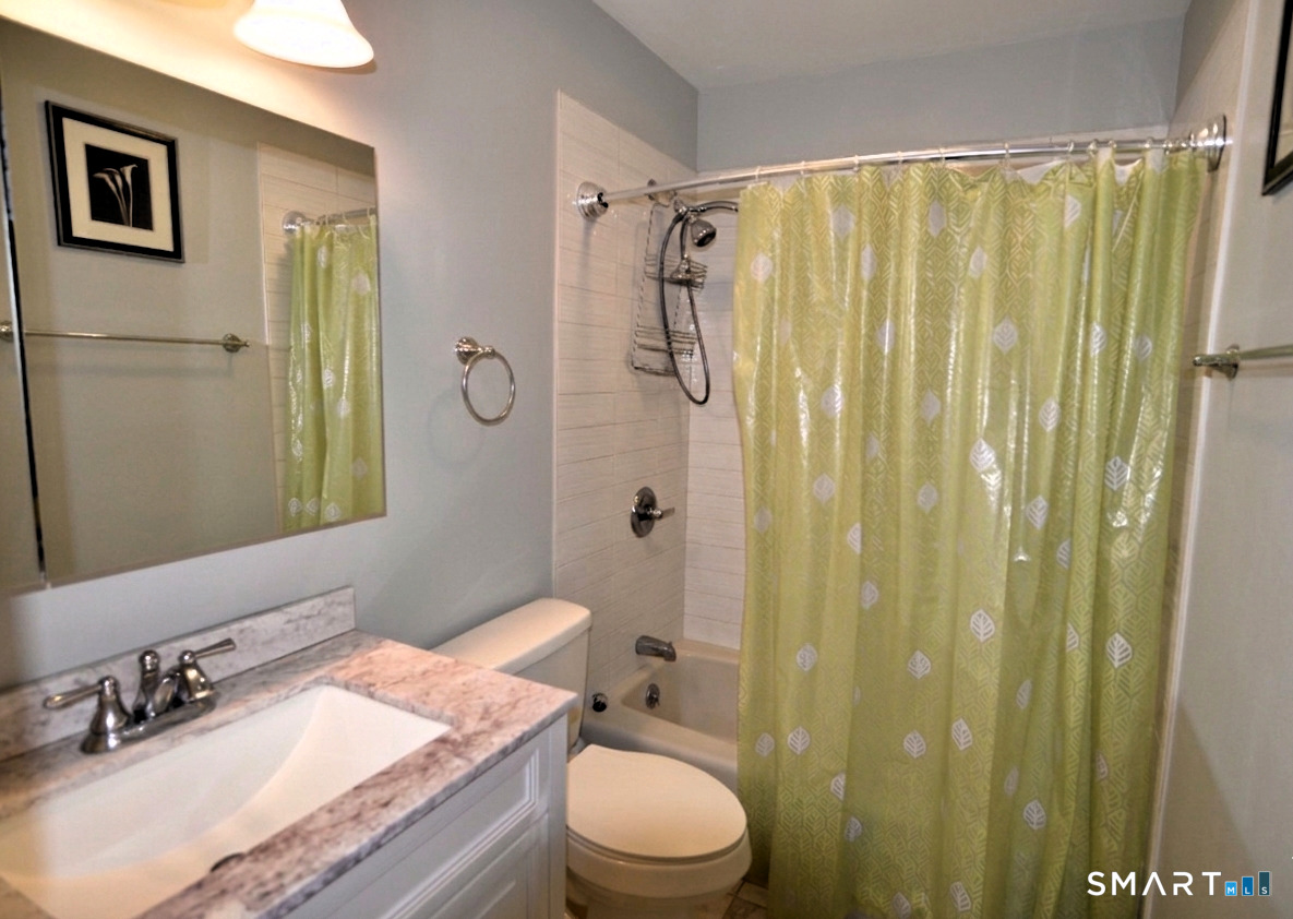 125 Warner Hill Road, Unit 67 Stratford, CT 06614 - Photo 10 of 14 This full bathroom shines with elegant tile flooring, a sleek granite vanity, and a relaxing tub/shower combo designed for unwinding in style