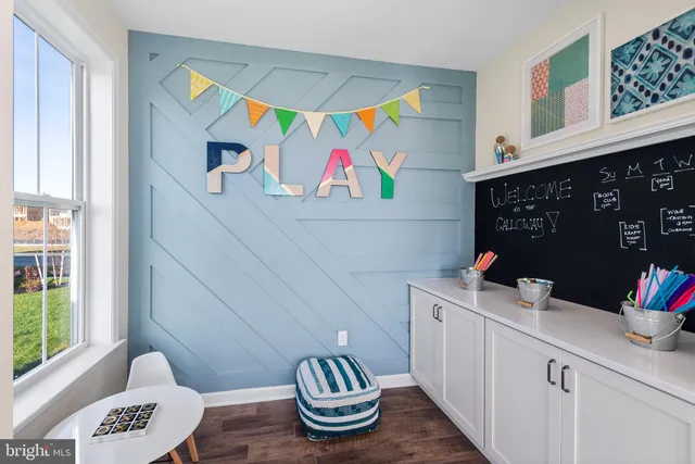 a bathroom with a sink a window and wall painting
