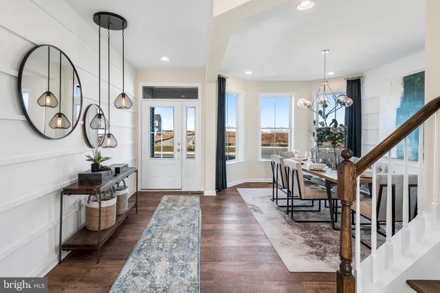 a view of entryway livingroom and hall with wooden floor