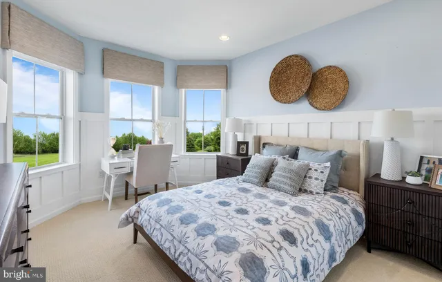 a bedroom with a large bed and a large window