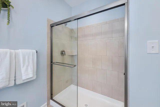 a bathroom with a glass shower door