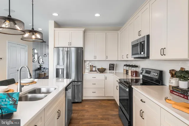 a kitchen with a sink stove and refrigerator