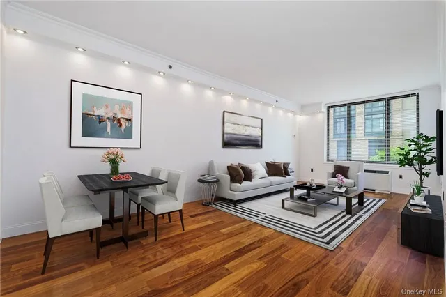 a living room with furniture rug and wooden floor
