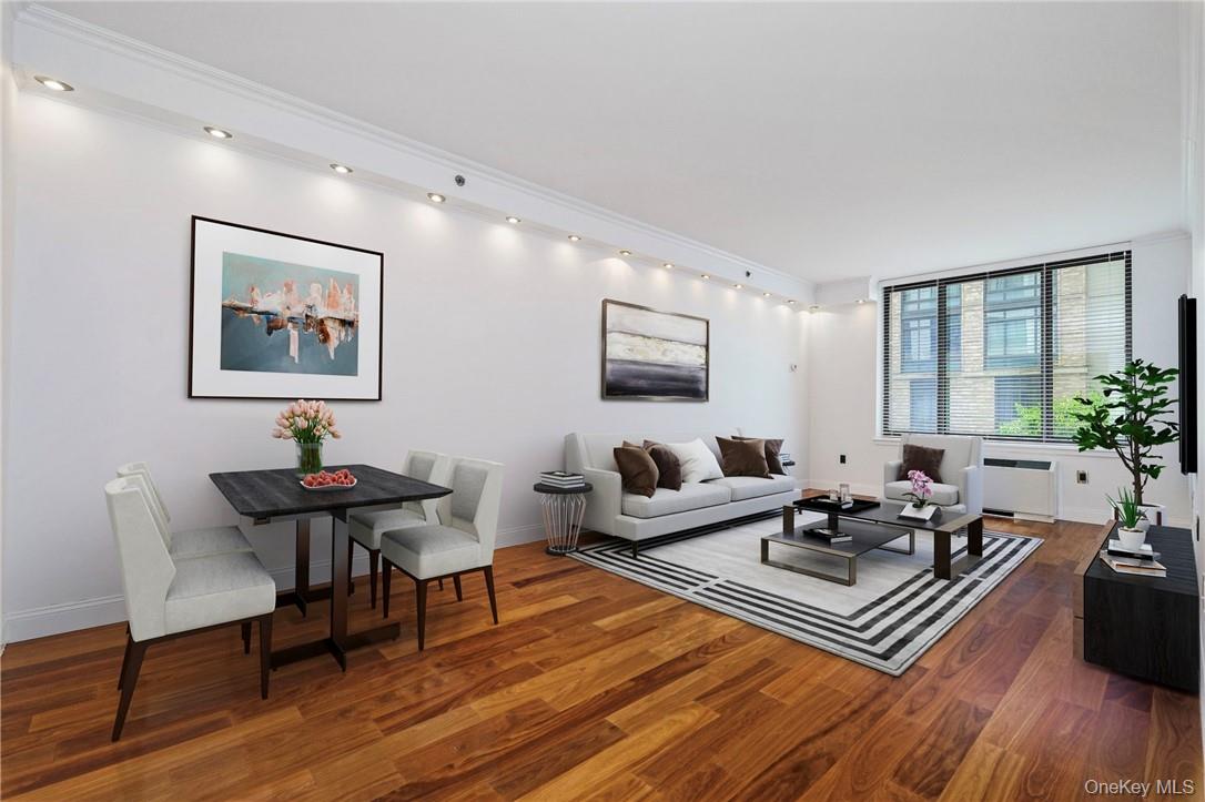 a living room with furniture rug and wooden floor