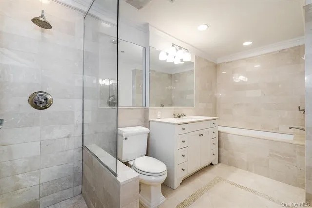 a bathroom with a granite countertop toilet a sink a mirror and shower
