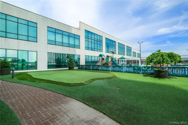 a view of house with a big yard and potted plants