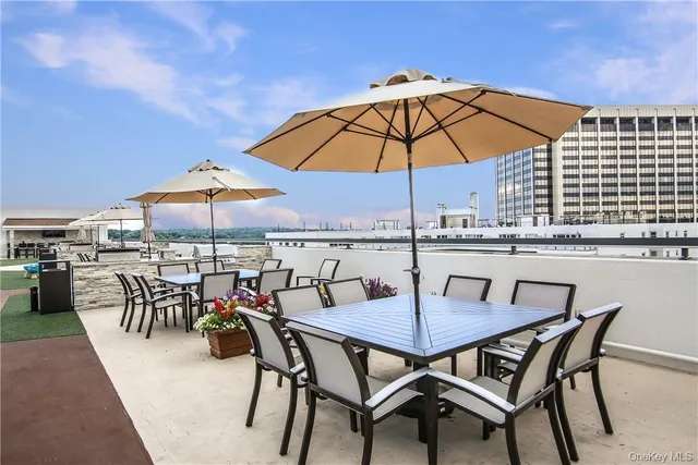 a view of an outdoor space with furniture and umbrella