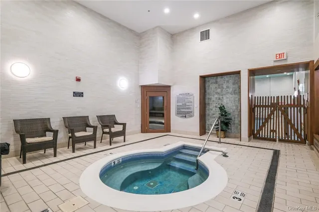 an outdoor space with swimming pool and furniture