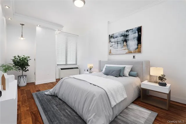a bedroom with bed and a potted plant