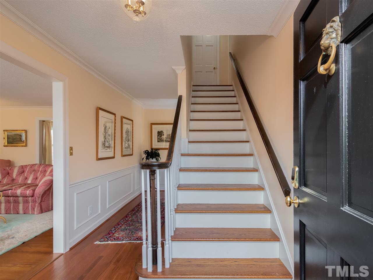 3745 Lassiter Mill Road Raleigh, NC 27609 - Photo 3 of 25 a view of an entryway with wooden floor and stairs