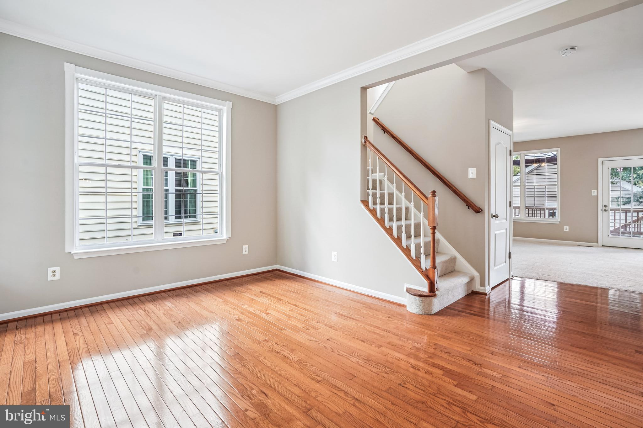 26096 Flintonbridge Drive Chantilly, VA 20152 - Photo 5 of 69 a view of an empty room with wooden floor and a window