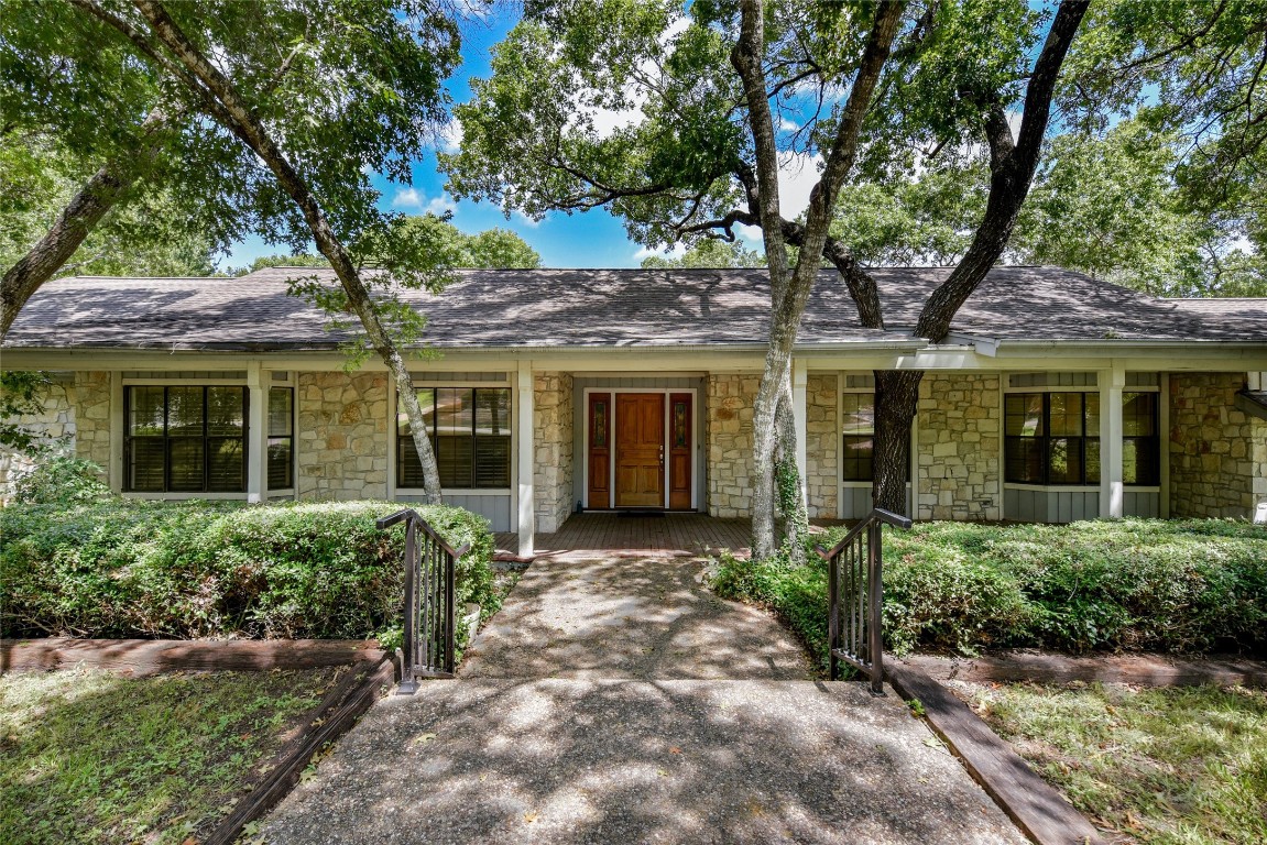 front view of a house with a tree in front of it