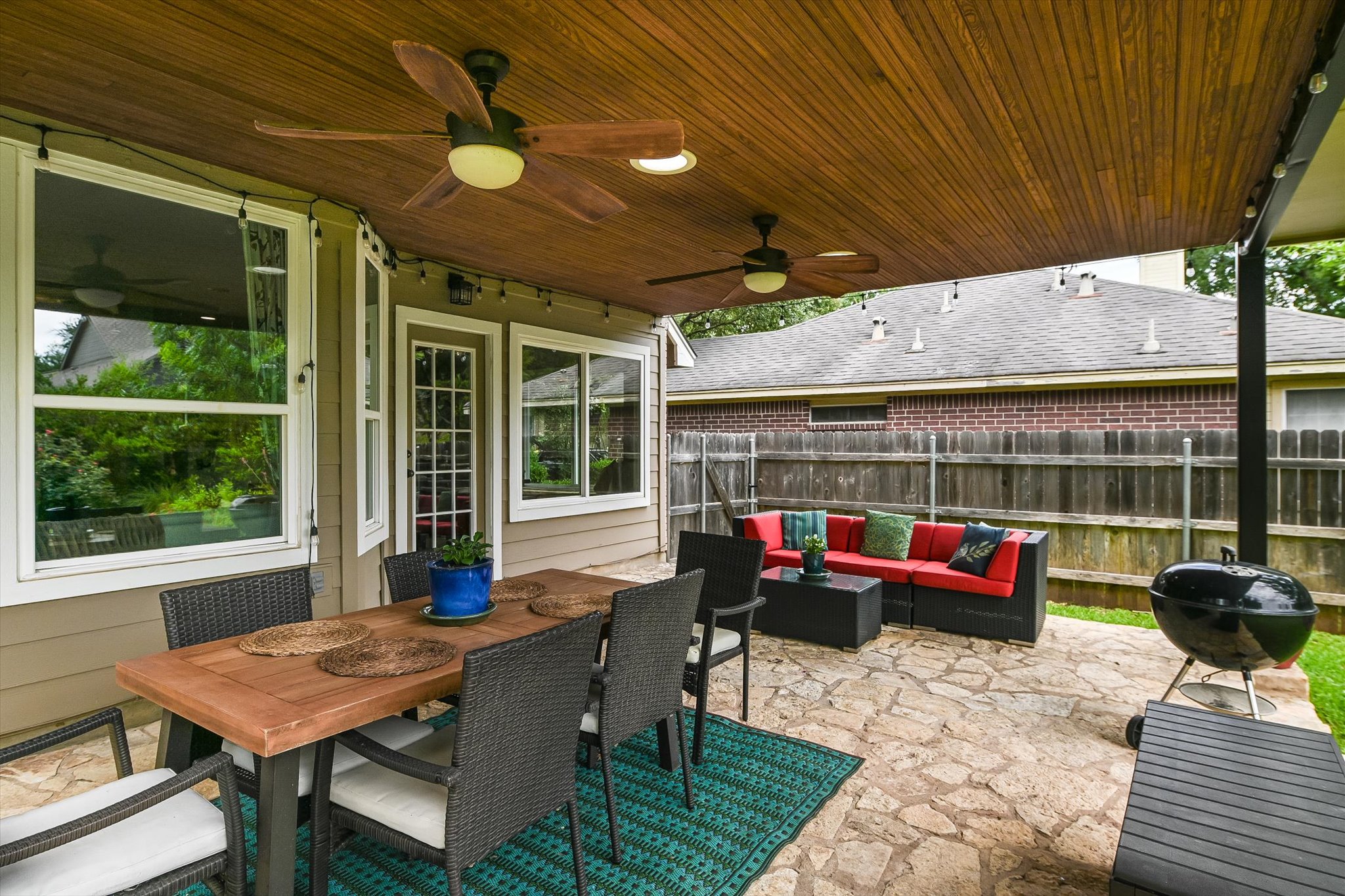 6456 Ruxton Lane Austin, TX 78749 - Photo 26 of 30 An inviting covered patio featuring flagstone flooring, a dining area, and a relaxed seating arrangement.