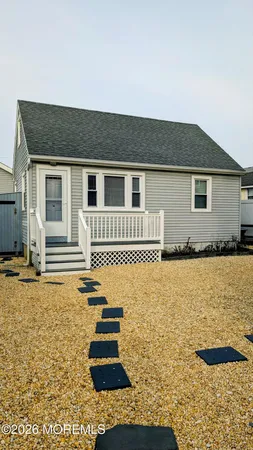 a backyard of a house with barbeque oven