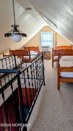 a bedroom with furniture and a window