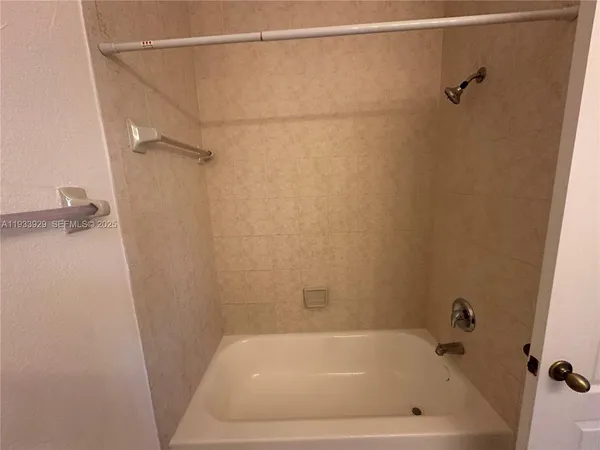a bathroom with a shower and a bath tub