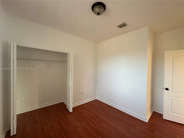 an empty room with wooden floor