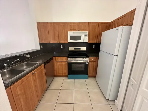 a kitchen with a refrigerator sink and stove