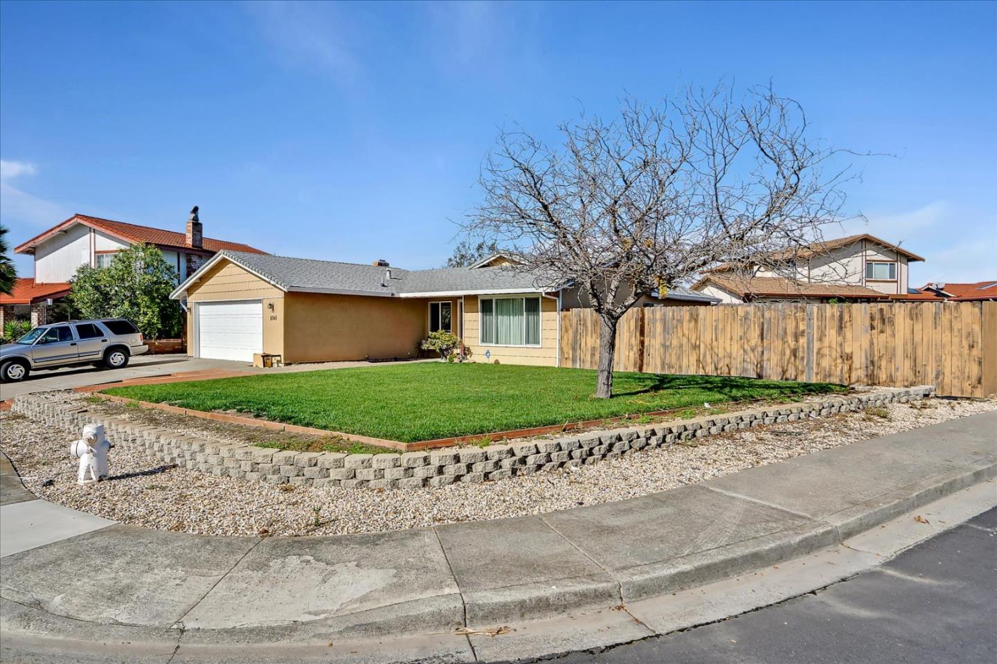 1045 Seascape Circle Rodeo, CA 94572 - Photo 3 of 6 a front view of a house with a garden