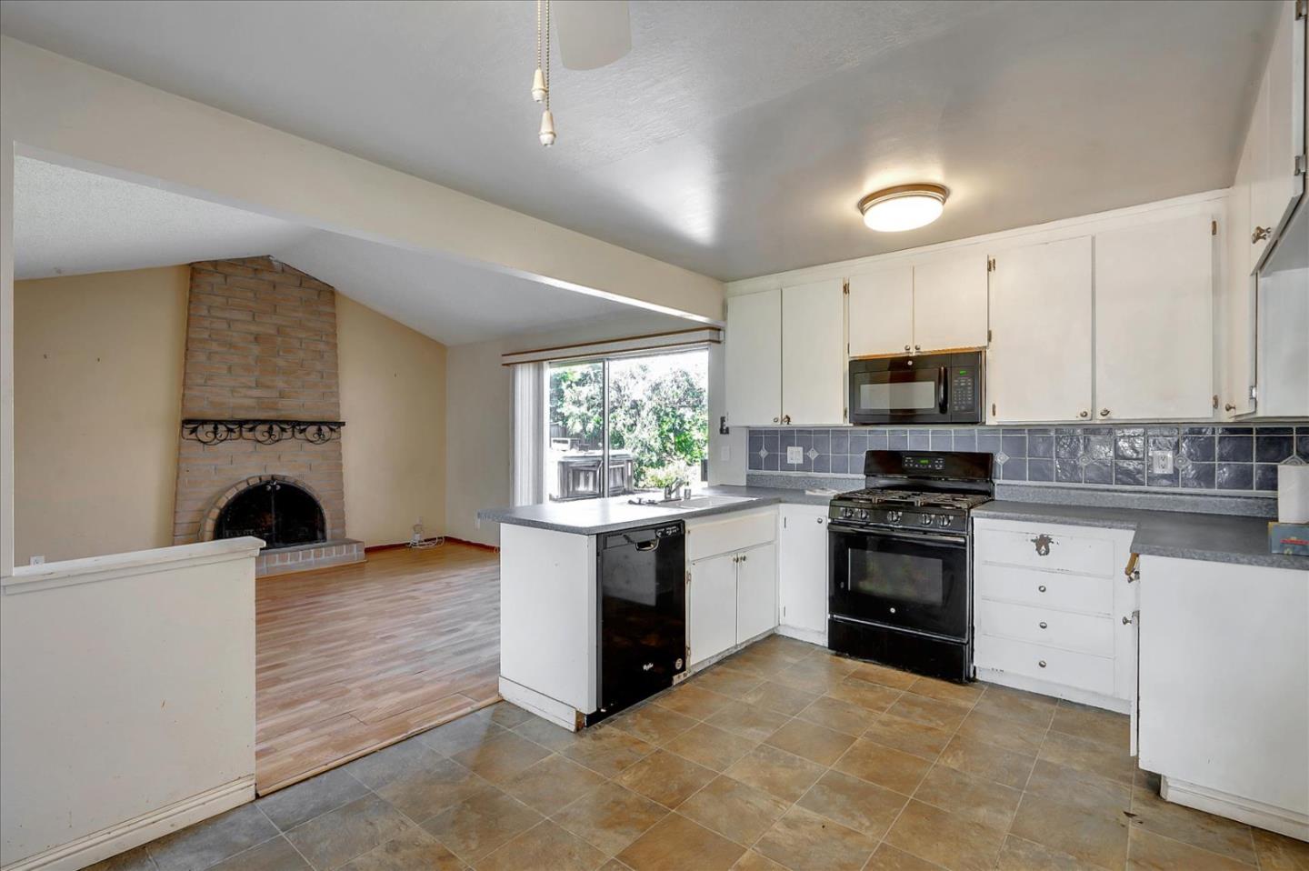 1045 Seascape Circle Rodeo, CA 94572 - Photo 6 of 6 a kitchen with stainless steel appliances a stove sink microwave and cabinets