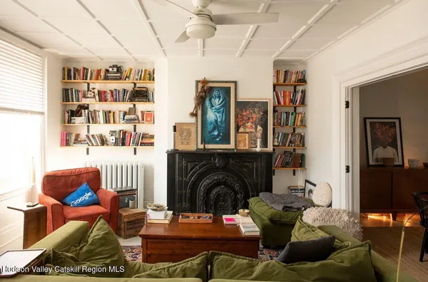 a living room with furniture a rug and a fireplace