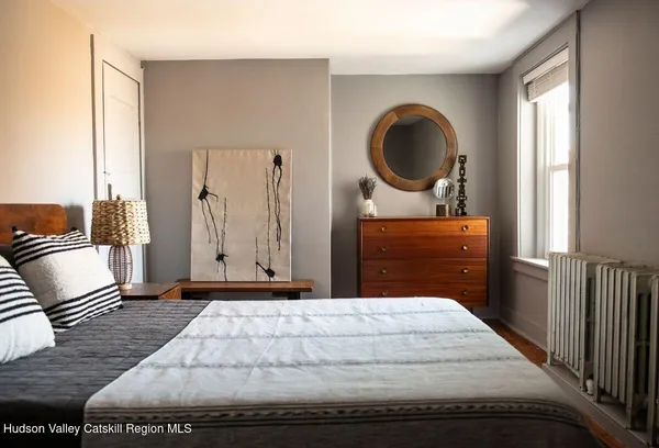a bedroom with a bed and a dresser
