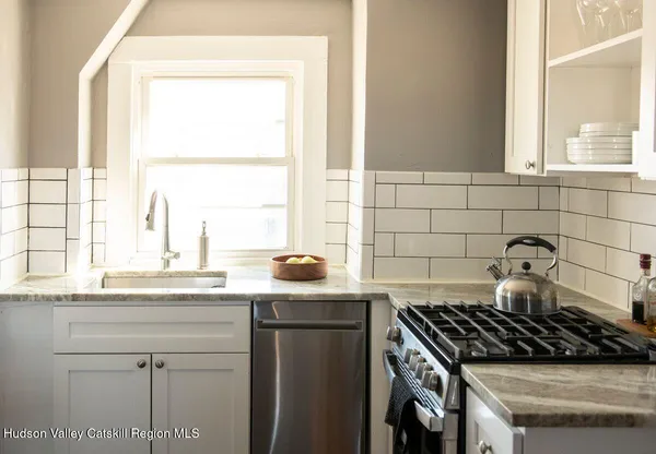 a stove top oven sitting next to a window