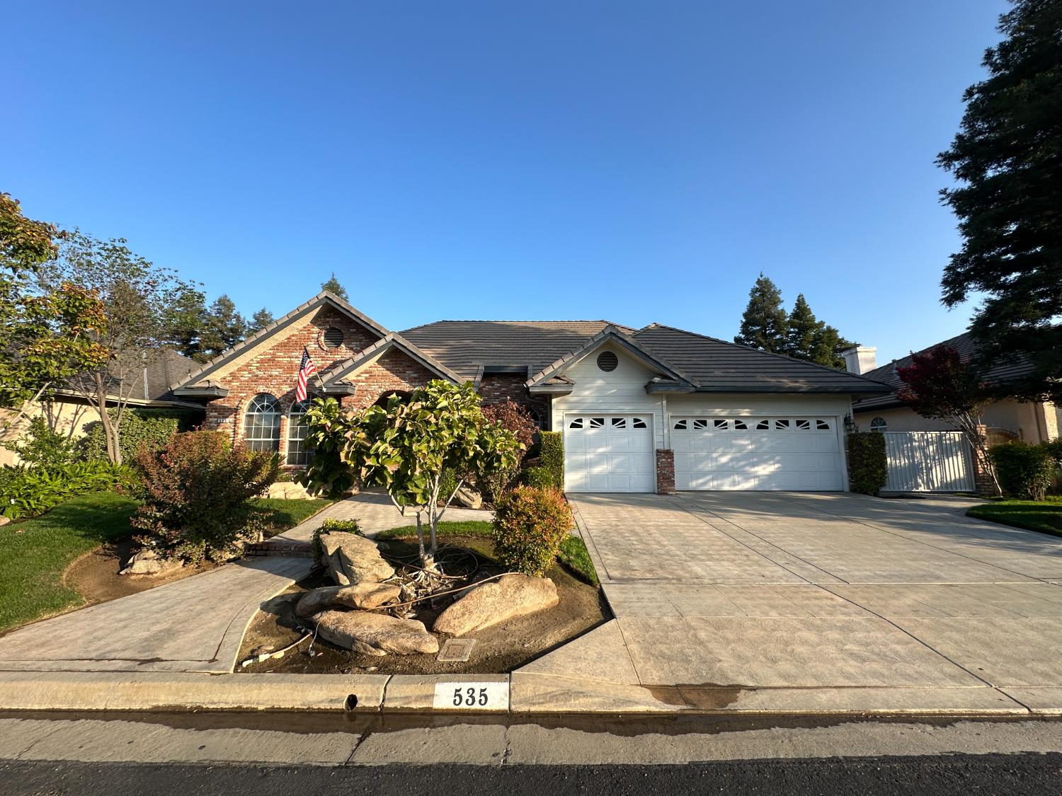 a view of a house with a yard and garage