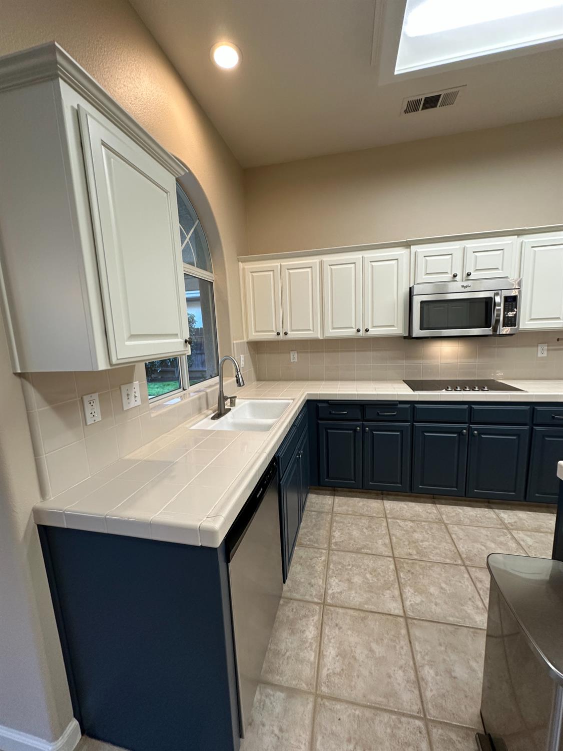 535 West Decatur Avenue Clovis, CA 93611 - Photo 15 of 51 a kitchen with a sink a stove top oven a counter space and cabinets