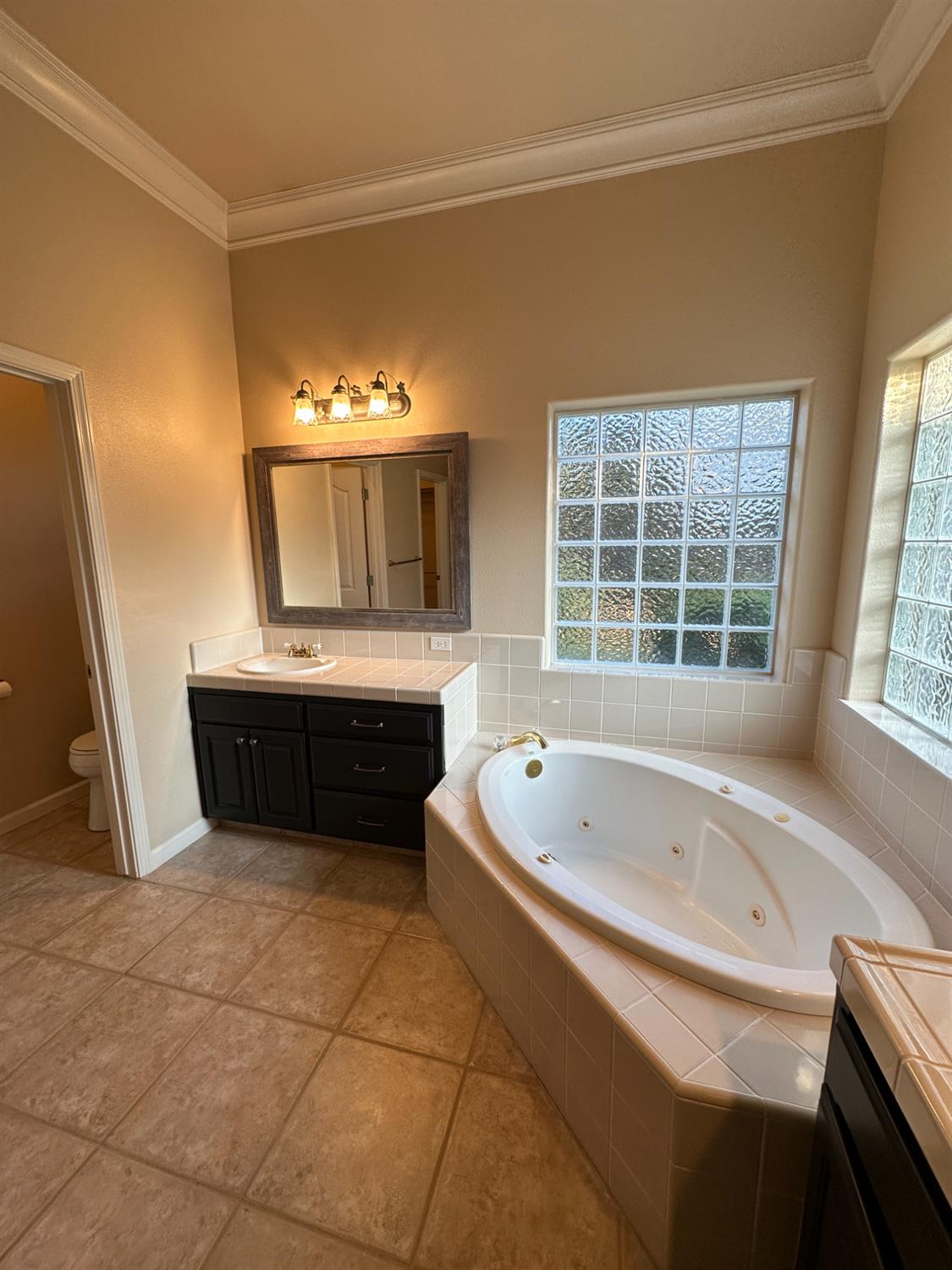 535 West Decatur Avenue Clovis, CA 93611 - Photo 36 of 51 a spacious bathroom with a tub sink and mirror