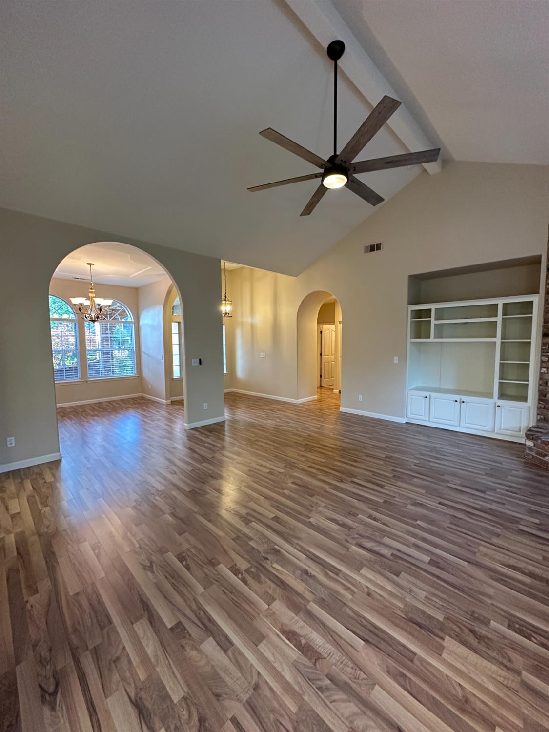 535 West Decatur Avenue Clovis, CA 93611 - Photo 9 of 51 an empty room with wooden floor fan and windows