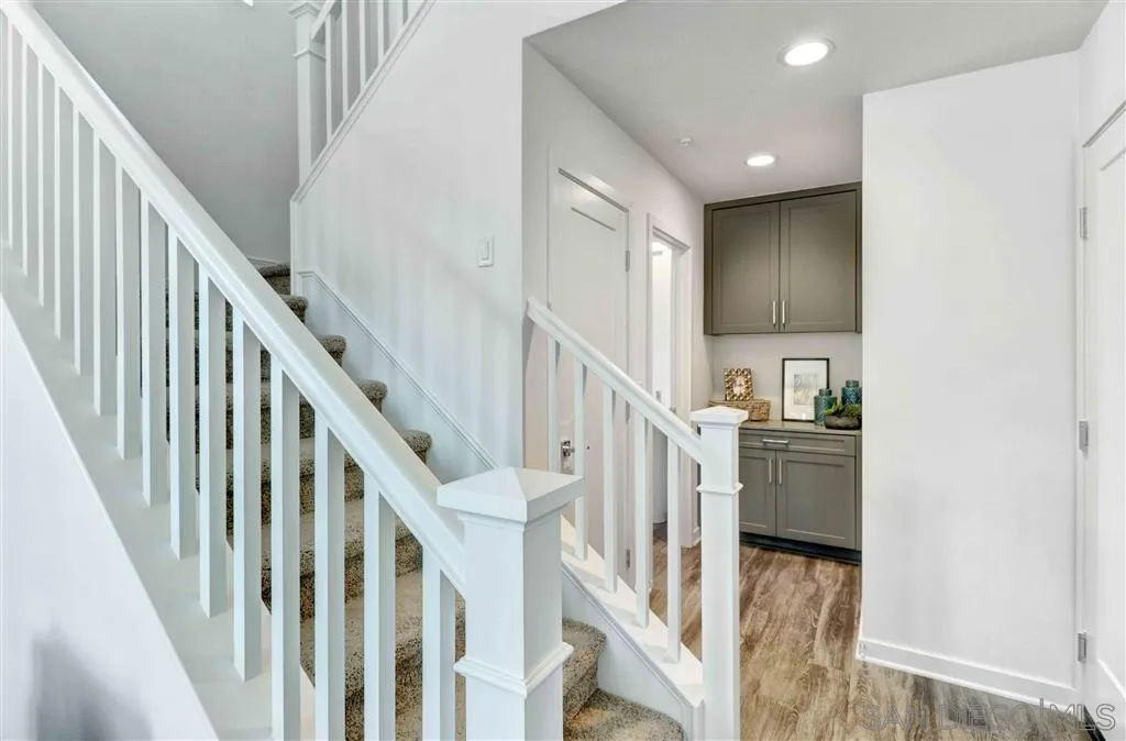 4007 Mission Inn Avenue Riverside, CA 92501 - Photo 13 of 25 a view of staircase and kitchen with wooden floor and pendant lights