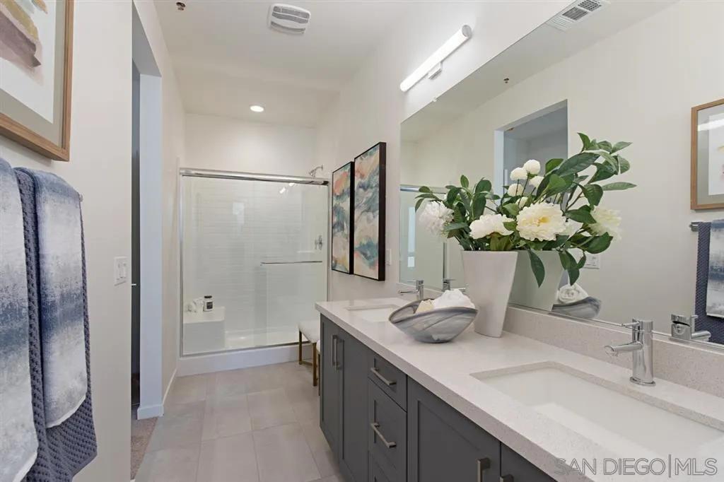 4007 Mission Inn Avenue Riverside, CA 92501 - Photo 17 of 25 a bathroom with a granite countertop shower a sink and a large mirror