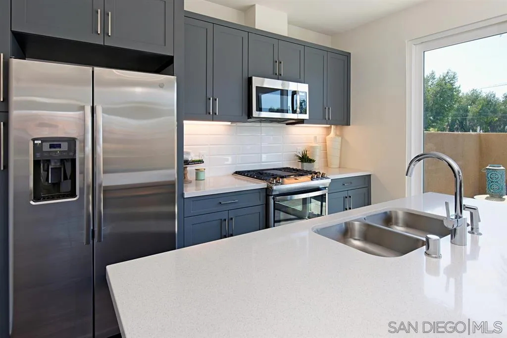 4007 Mission Inn Avenue Riverside, CA 92501 - Photo 10 of 25 a kitchen with stainless steel appliances kitchen island a refrigerator sink and microwave