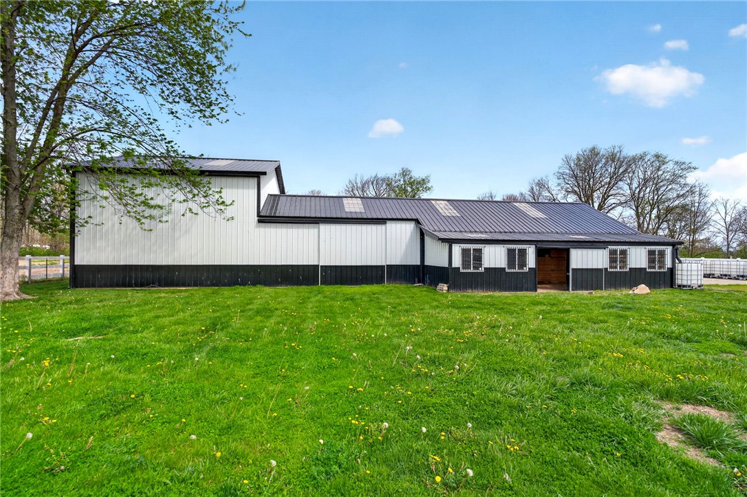 7988 McCool Road Greenville, OH 45331 - Photo 29 of 50 This spacious barn offers ample room for various agricultural or storage needs, set on a sprawling green landscape.