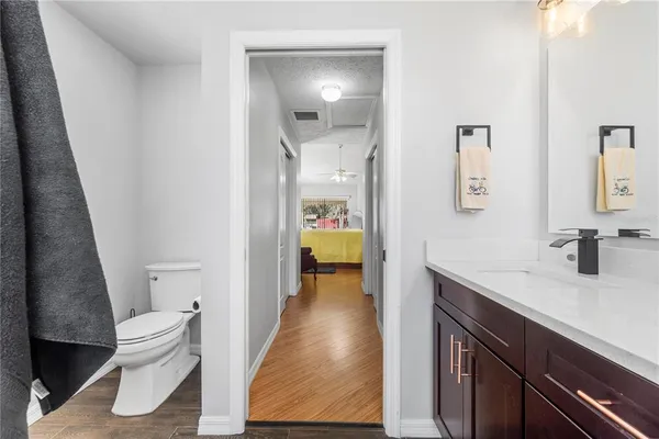 a view of a hallway with wooden floor and closet
