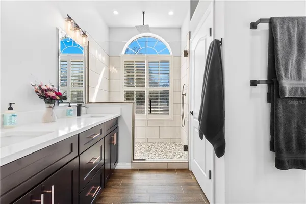 a bed room with a bed and a chandelier